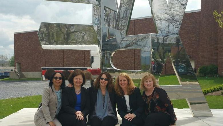 Group of women in front of We Are sign