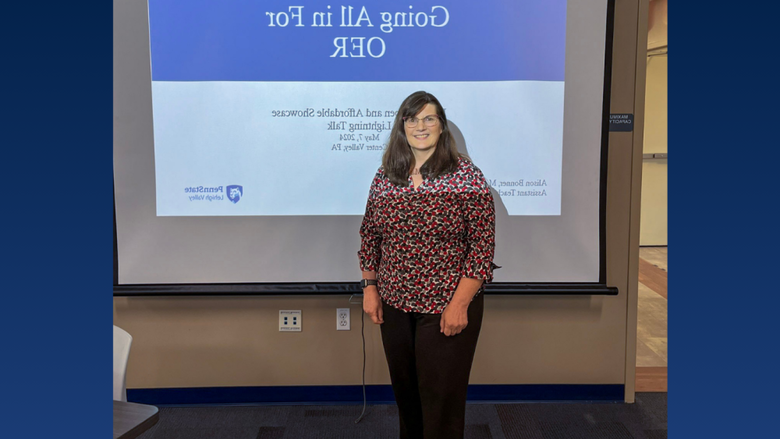 a female professor smiling in front of a classroom 