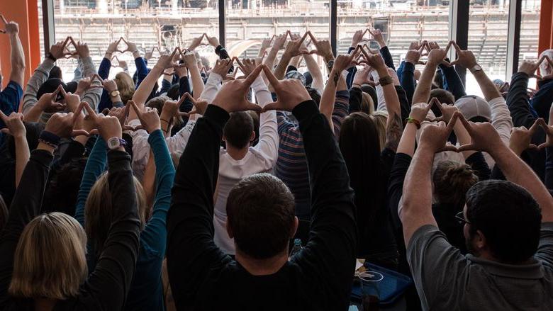 Group of people put their hands up in diamonds shape