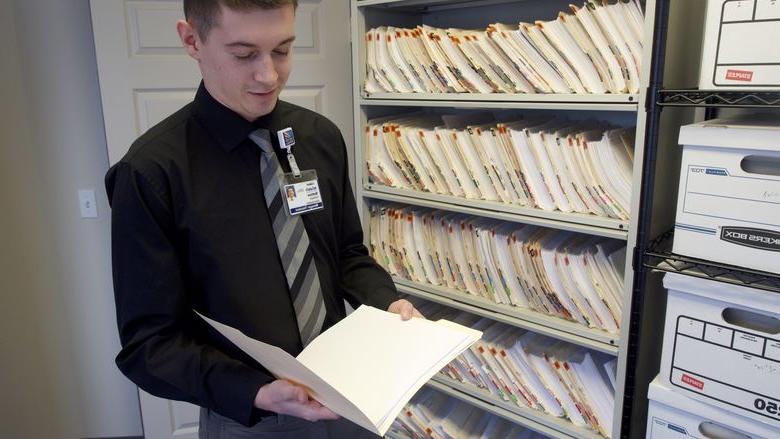 young man examining a file