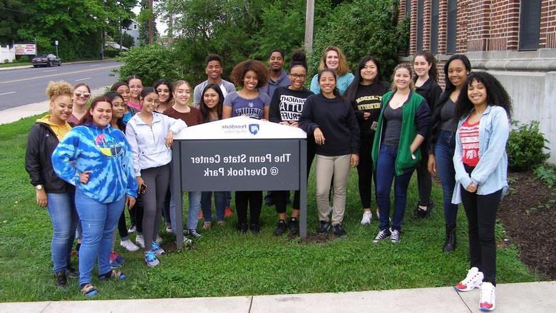 group of high school students by a sign