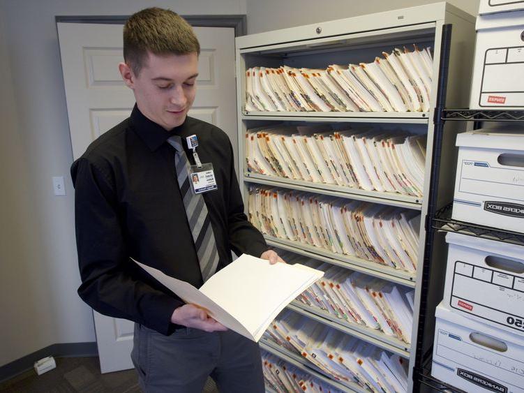 young man examining a file