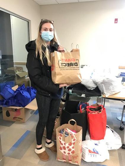 Victoria Stopper holds clothing bag donation 